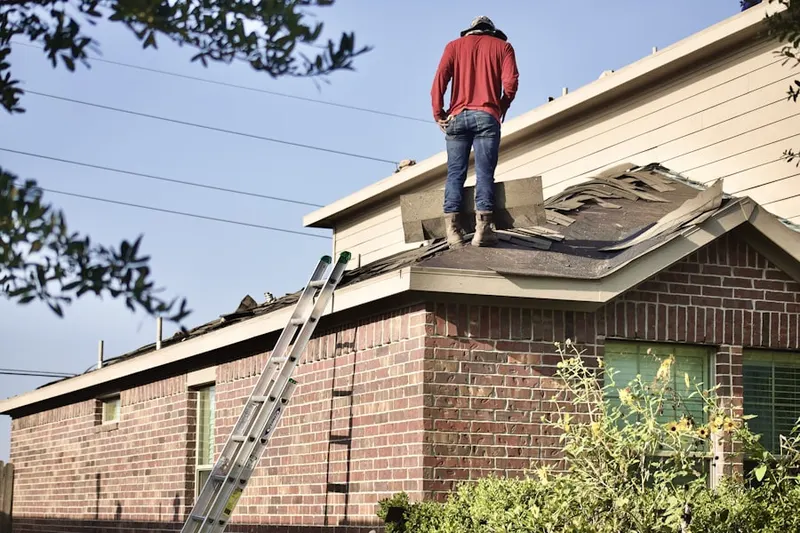 Professional roofer working on a residential roof in Keystone Point